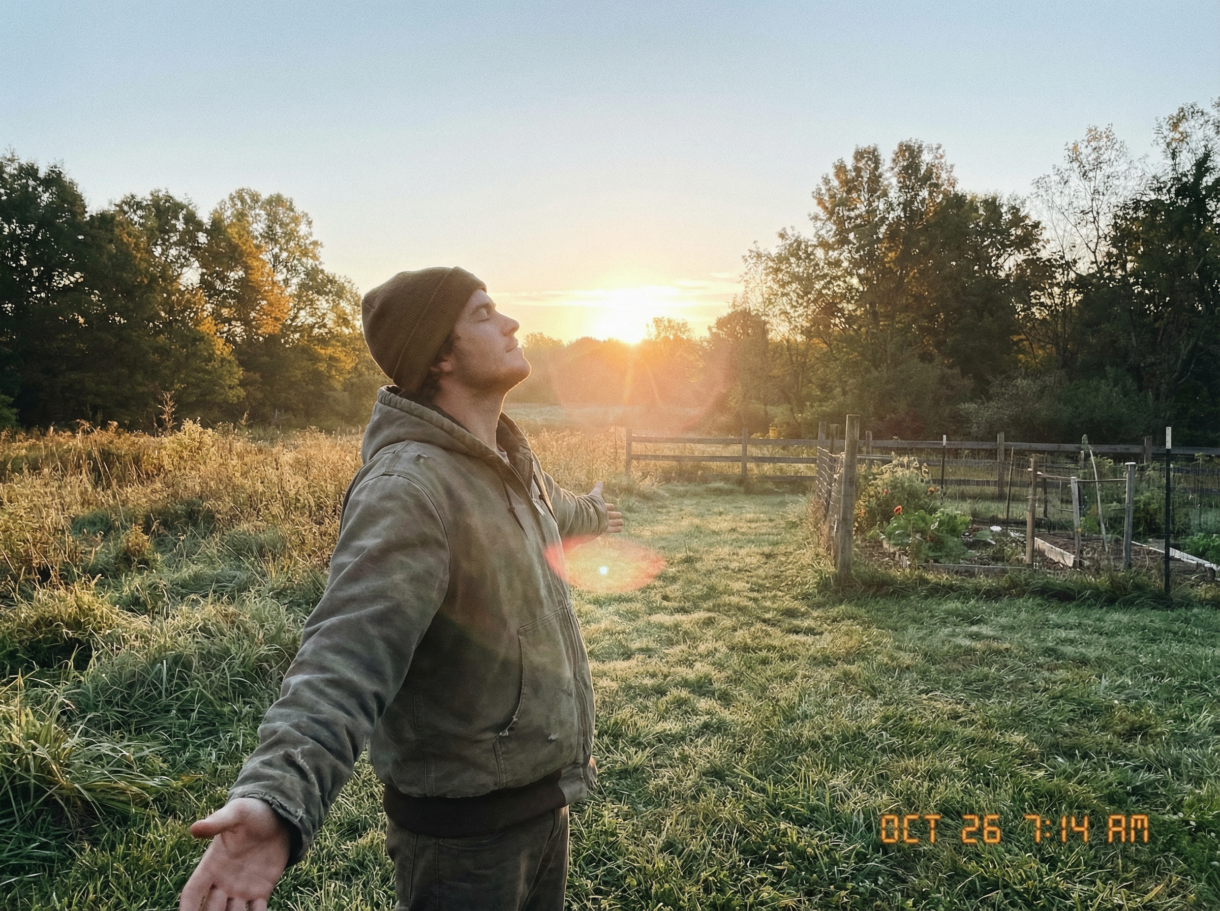 Person standing outside at sunrise in a garden, arms open, morning light, empowerment and sovereignty